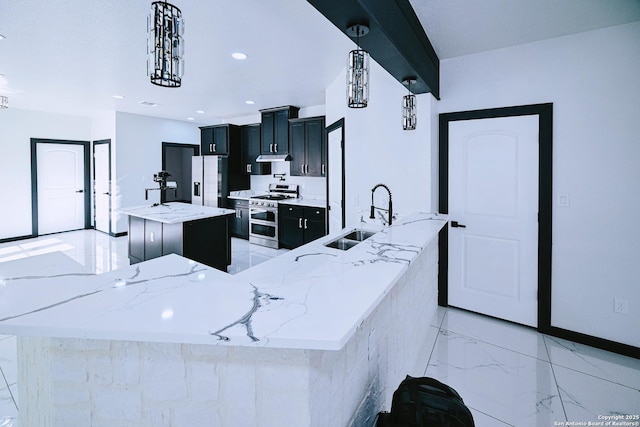 kitchen with light stone counters, range with two ovens, a large island, fridge with ice dispenser, and sink