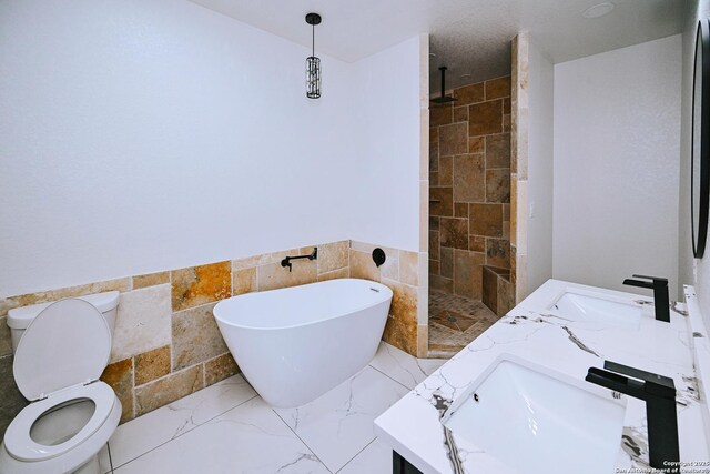 full bathroom featuring toilet, shower with separate bathtub, tile walls, and vanity