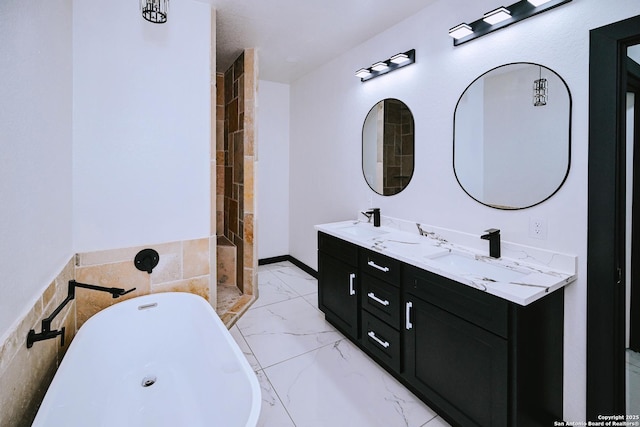 bathroom with a tub and vanity