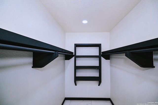 spacious closet featuring light tile patterned flooring