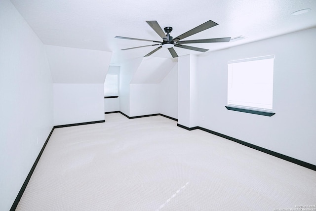 additional living space featuring vaulted ceiling, ceiling fan, and light carpet