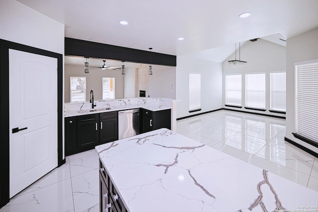 kitchen with light stone counters, stainless steel dishwasher, decorative light fixtures, ceiling fan, and sink