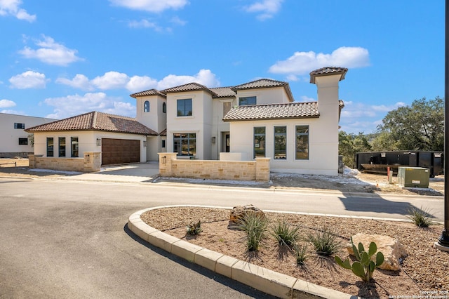 mediterranean / spanish house with a garage