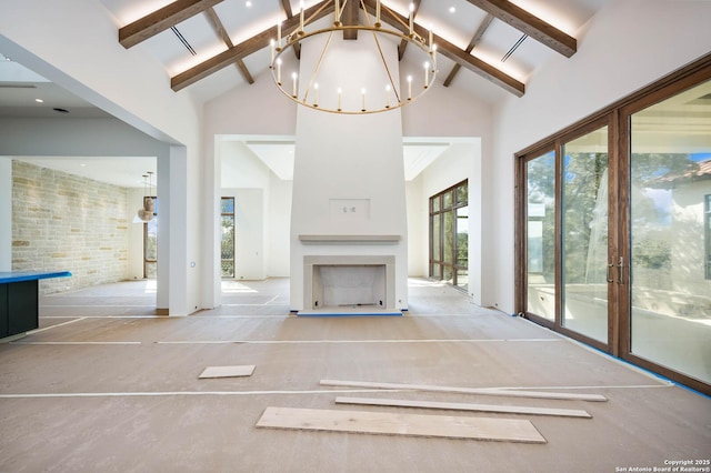 unfurnished living room featuring an inviting chandelier, high vaulted ceiling, and beamed ceiling