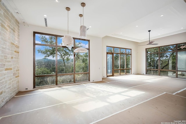 unfurnished dining area with a mountain view and ceiling fan