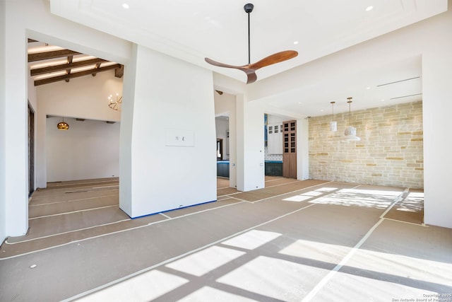 empty room with a fireplace and beamed ceiling