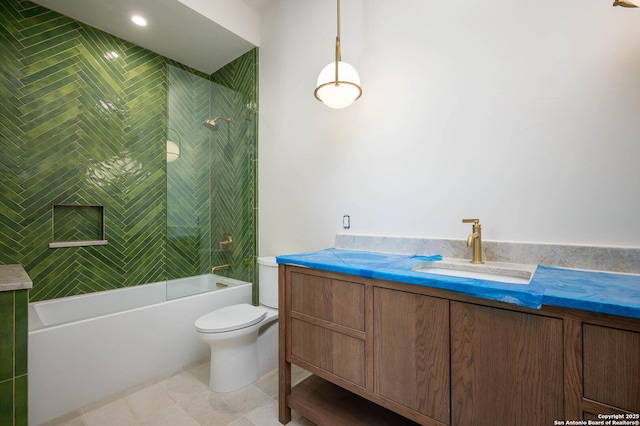 full bathroom featuring tile patterned floors, vanity, toilet, and tiled shower / bath combo