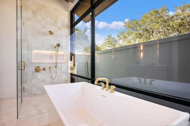 bathroom featuring separate shower and tub and tile patterned flooring