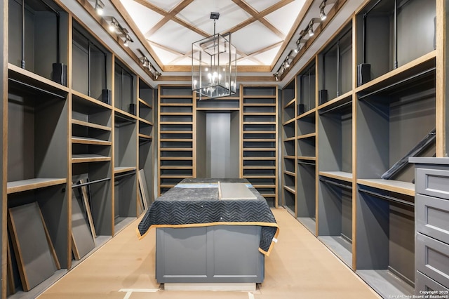 spacious closet featuring a notable chandelier