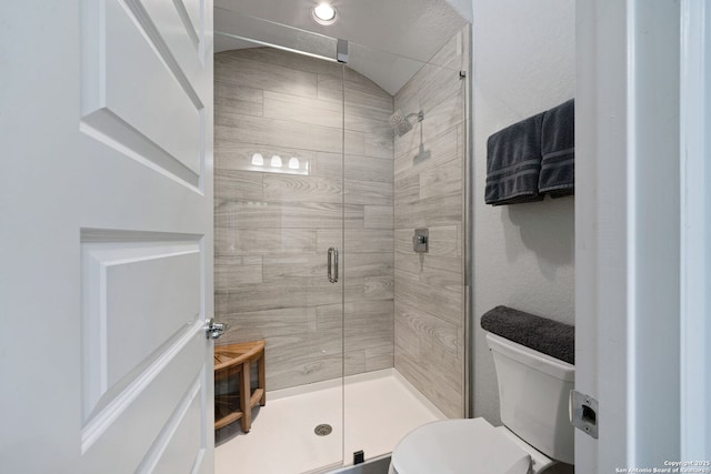 bathroom with toilet and walk in shower