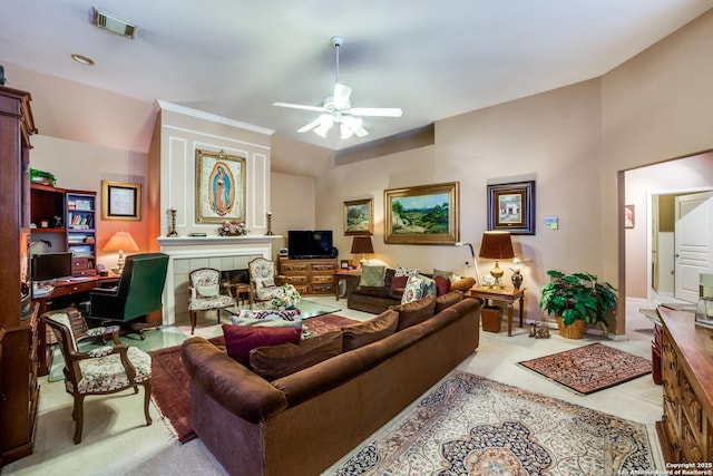 carpeted living room featuring vaulted ceiling, a tiled fireplace, and ceiling fan