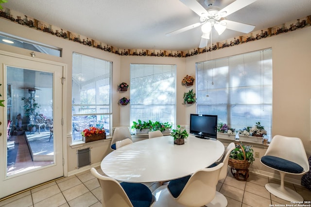 tiled dining area with ceiling fan