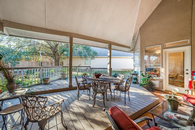 sunroom / solarium featuring lofted ceiling