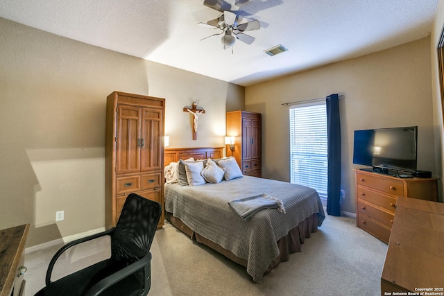 bedroom with ceiling fan and light carpet