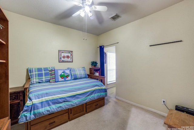 bedroom with ceiling fan and light carpet