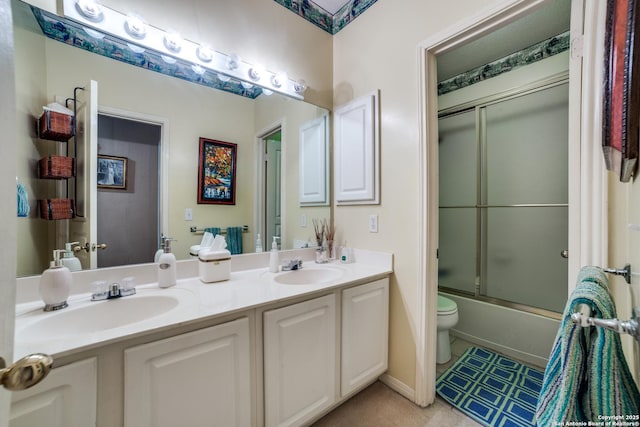 full bathroom with toilet, enclosed tub / shower combo, and vanity