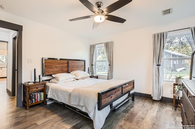 bedroom with ceiling fan and dark hardwood / wood-style flooring