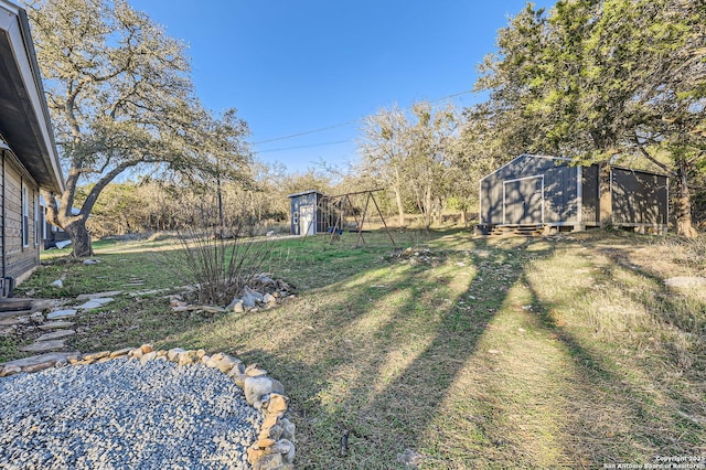 view of yard with a playground and a storage shed