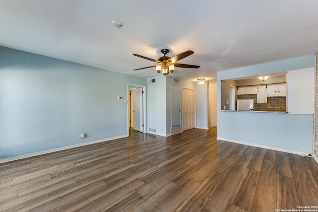 unfurnished living room with hardwood / wood-style flooring and ceiling fan