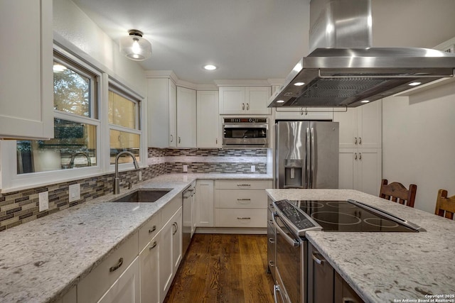 kitchen featuring white cabinetry, island exhaust hood, appliances with stainless steel finishes, and sink