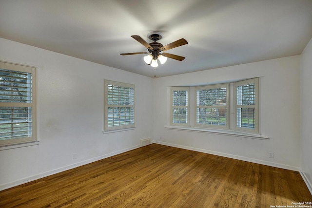 unfurnished room with hardwood / wood-style floors and ceiling fan