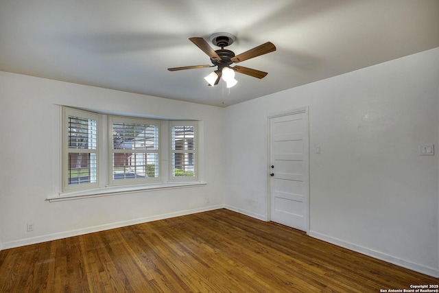 spare room featuring hardwood / wood-style floors and ceiling fan