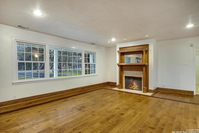 unfurnished living room featuring wood-type flooring