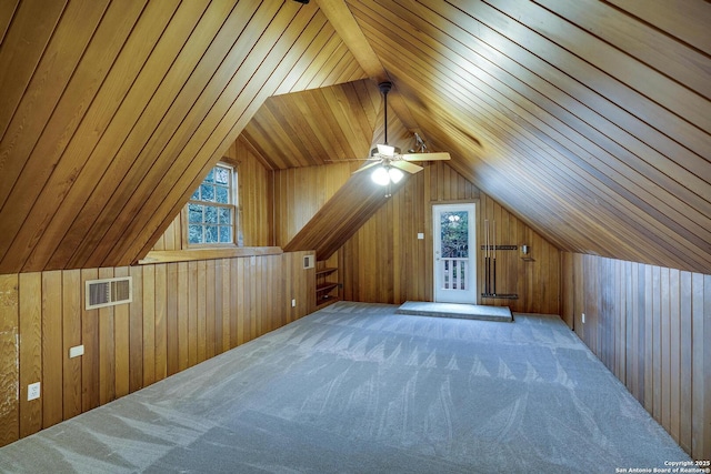 bonus room with vaulted ceiling, carpet, wood ceiling, and wood walls