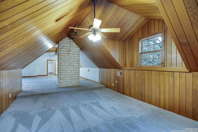 additional living space with vaulted ceiling, light colored carpet, wooden ceiling, and wood walls