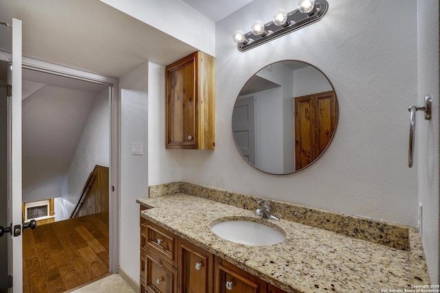 bathroom with vanity and hardwood / wood-style floors