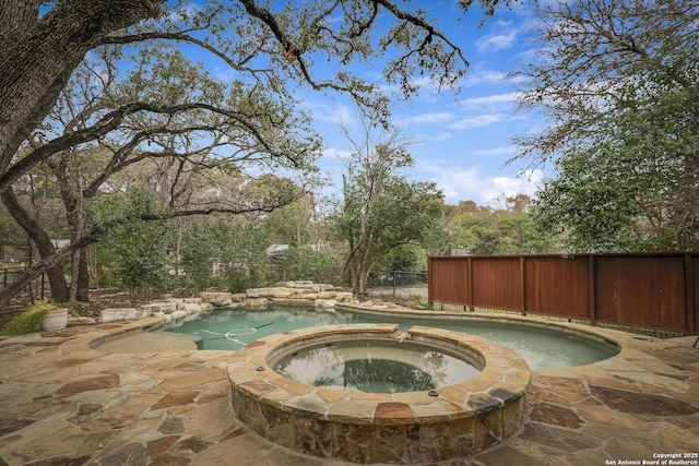 view of swimming pool with a patio and an in ground hot tub