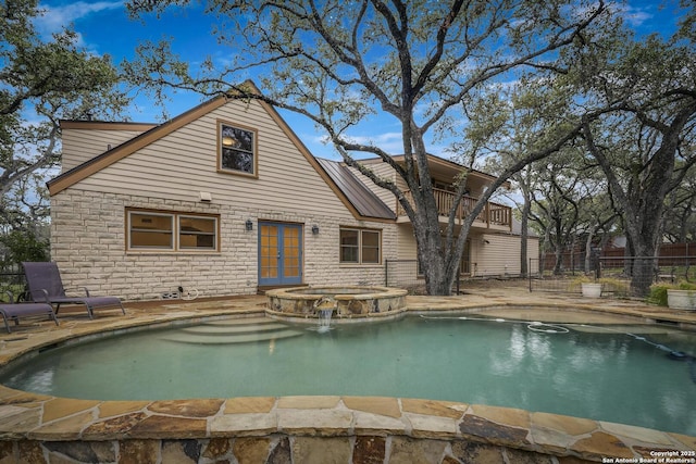 view of pool featuring a patio area and an in ground hot tub