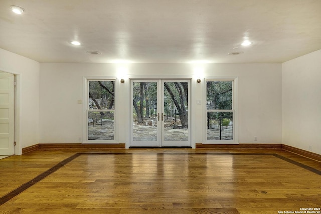 unfurnished room with hardwood / wood-style flooring