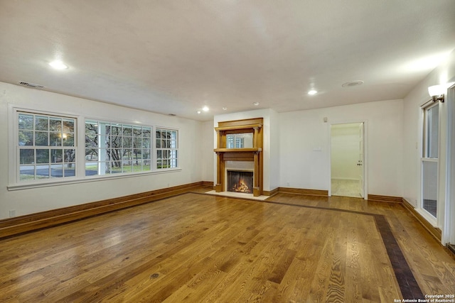 unfurnished living room with wood-type flooring