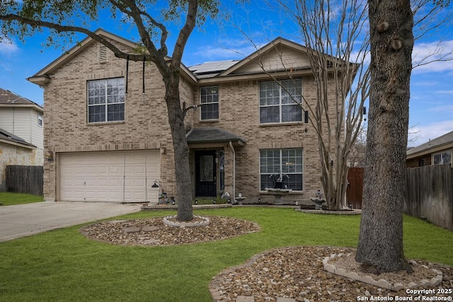 front of property with solar panels, a front yard, and a garage