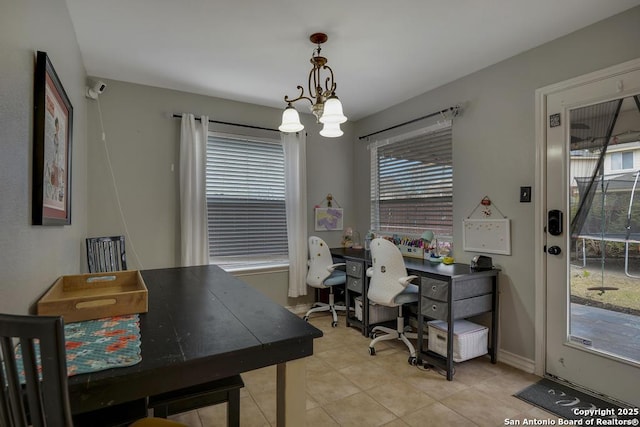 tiled office with a notable chandelier