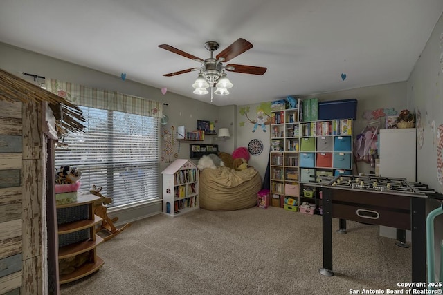 game room with ceiling fan, a healthy amount of sunlight, and carpet