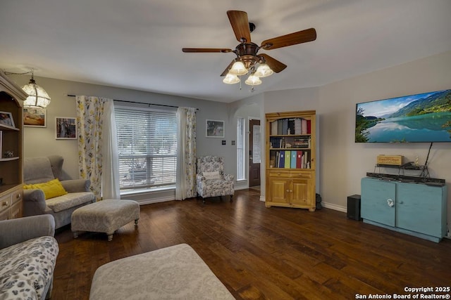 living room with ceiling fan and dark wood-type flooring