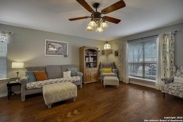 living room with ceiling fan and dark hardwood / wood-style flooring