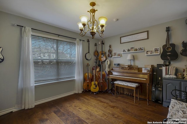 misc room with dark wood-type flooring and a chandelier