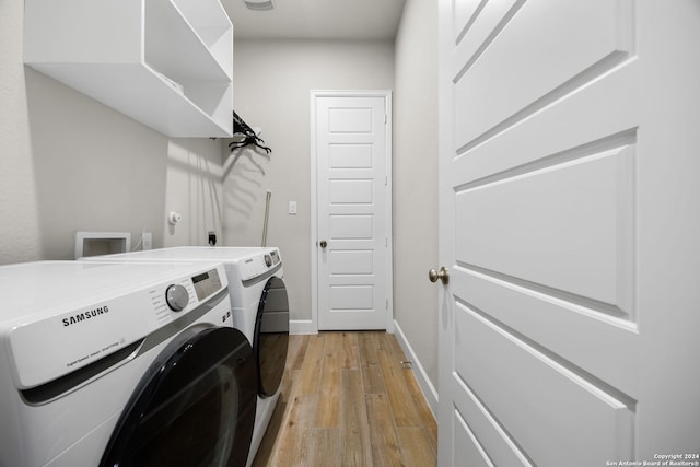 washroom with washer and dryer and light hardwood / wood-style floors