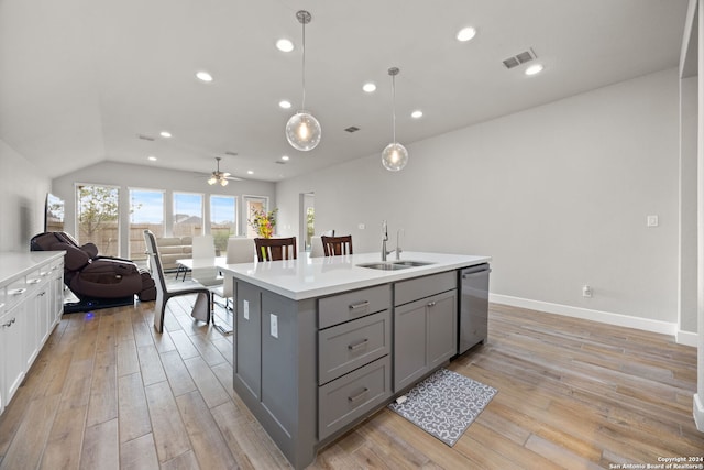 kitchen featuring sink, dishwasher, pendant lighting, gray cabinets, and a kitchen island with sink