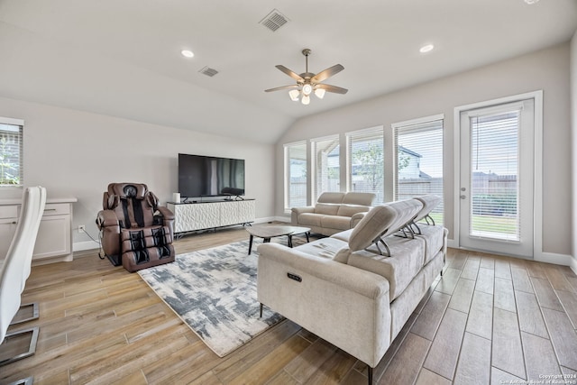 living room featuring ceiling fan and lofted ceiling