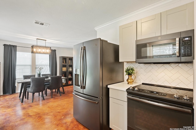 kitchen featuring decorative backsplash, appliances with stainless steel finishes, crown molding, and pendant lighting