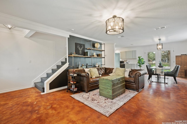 living room featuring concrete flooring, ornamental molding, and french doors