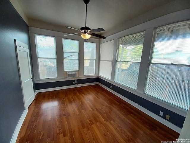 unfurnished sunroom with ceiling fan, cooling unit, and plenty of natural light