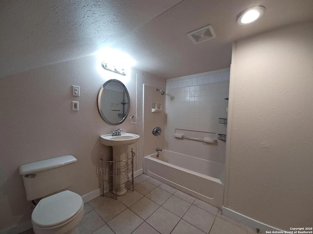 full bathroom with toilet, tiled shower / bath combo, sink, and tile patterned floors