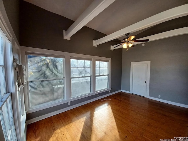 spare room featuring ceiling fan, hardwood / wood-style floors, and beamed ceiling