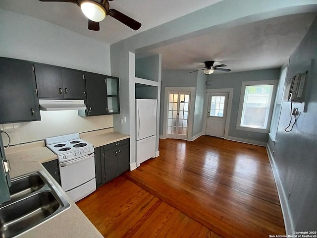 kitchen featuring ceiling fan, sink, white appliances, and dark hardwood / wood-style floors