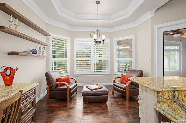 sitting room with ornamental molding, a tray ceiling, plenty of natural light, and dark hardwood / wood-style floors